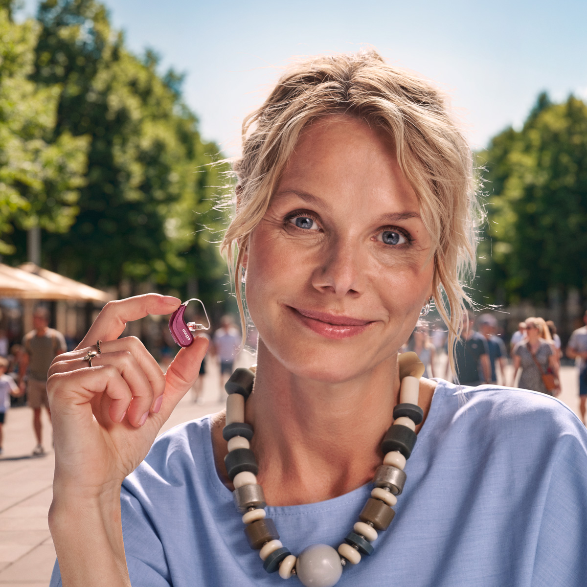 Oticon hearing aids help a man enjoy a meaningful moment with a young child outdoors, showing the connection and clarity better hearing can support.