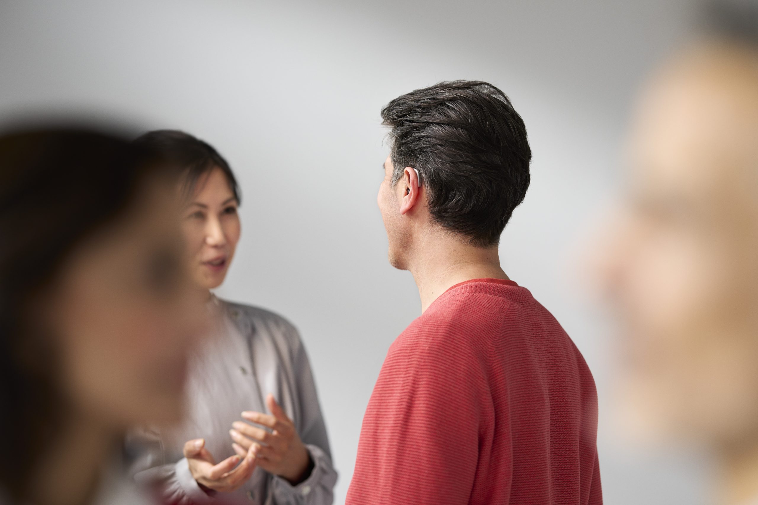 Young women, with a ReSound hearing aid. ReSound Vivia, a small BTE hearing aid.